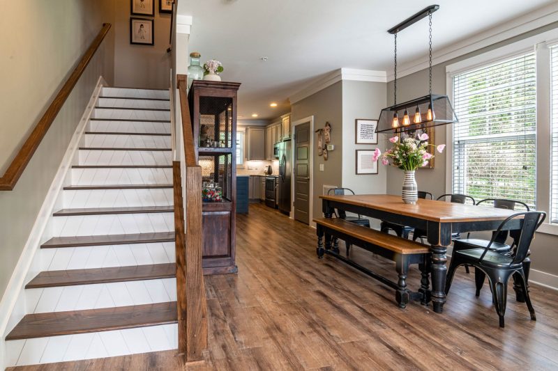 Home 143 Bright and inviting dining area features a wooden table stai 1784048529